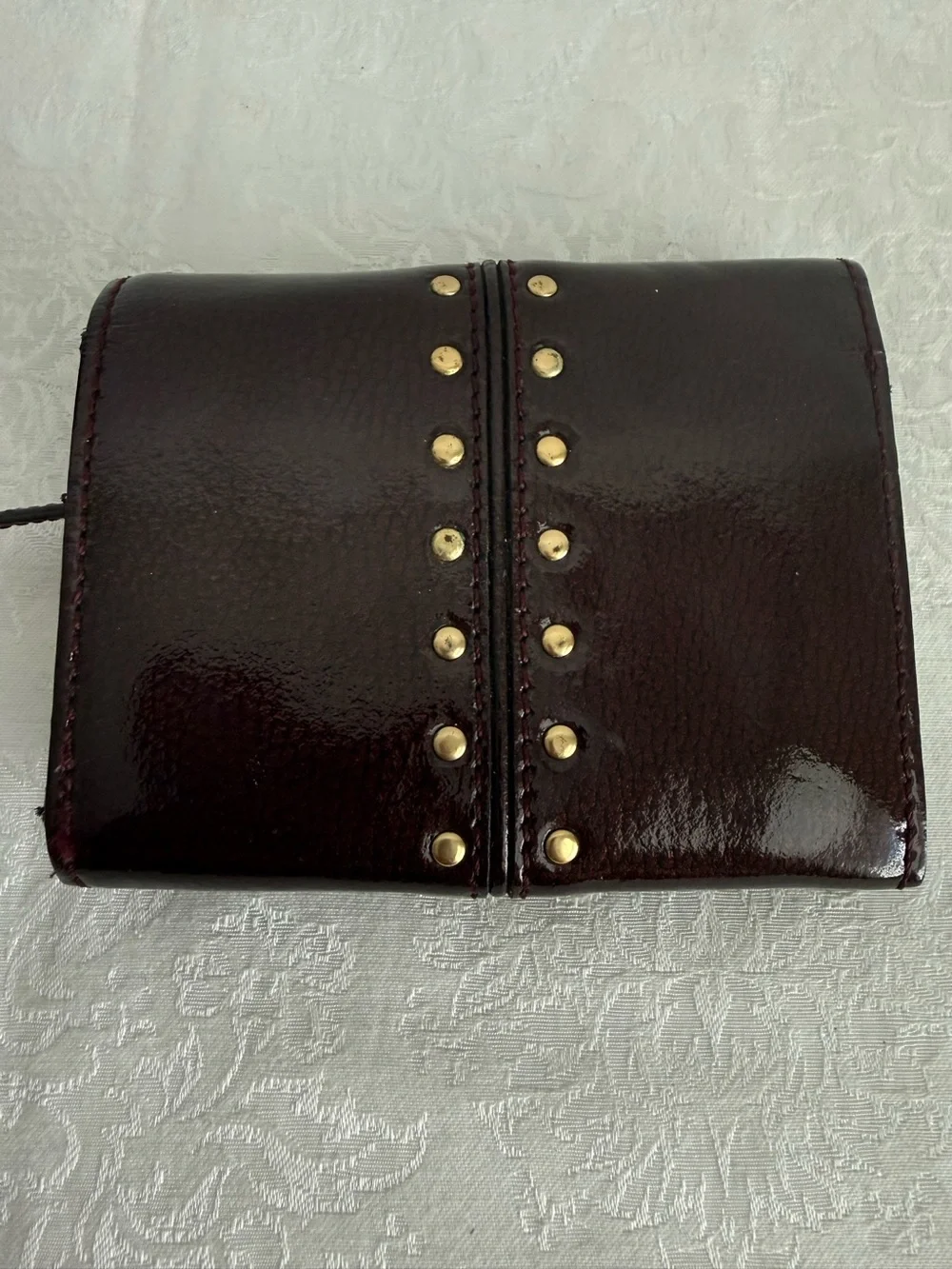 Michael Kors Burgundy patent bifold wallet with Gold Studs
